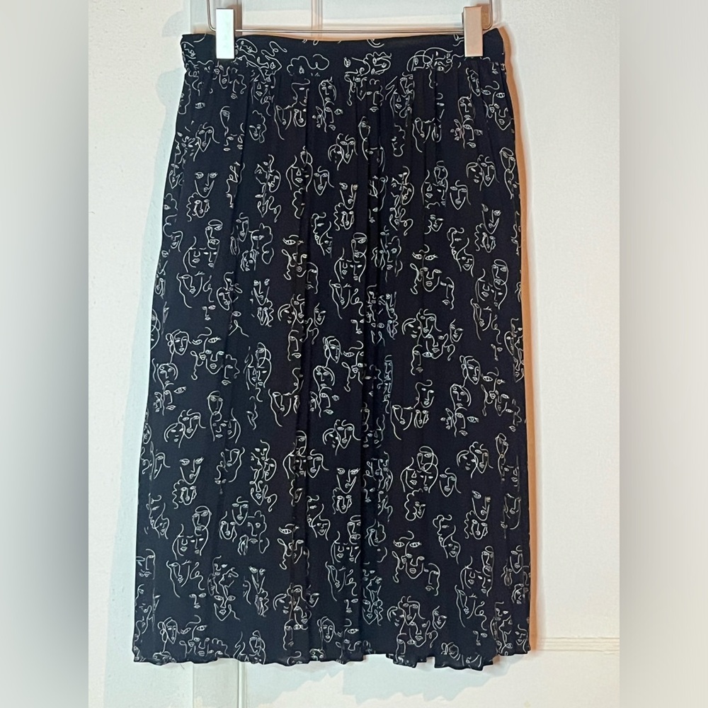 Abstract art faces pleated skirt